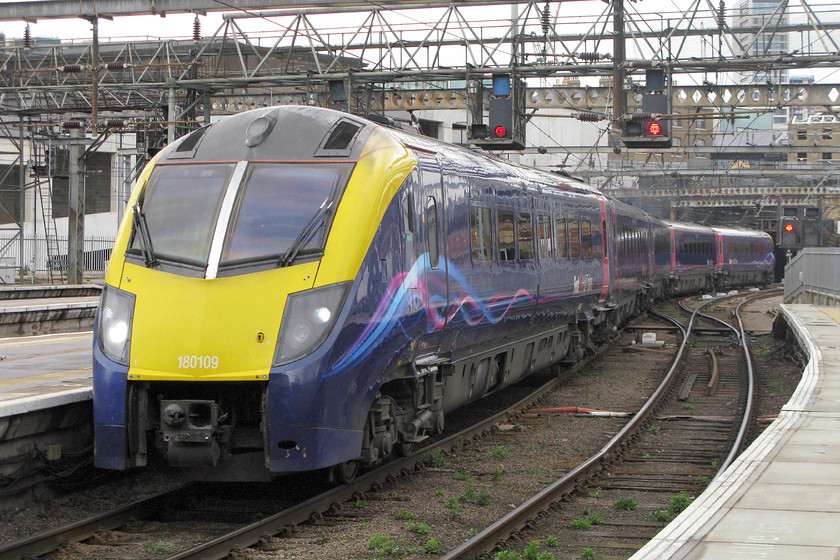 180109, HT 10.30 Hull-London King`s Cross (1A93), King`s Cross station 
 FirstGroup is the parent company of open access operator Hull Trains who started operations on the ECML in 2000. Since this time, they have operated a number of different trains from the highly unsatisfactory class 172 DMUs to a set of Mk.III stock hauled by an 86 and DVT. Today, they operate a fleet of cast-off class 180 Adelantes one of which is seen here arriving at King's Cross. 180109 is just arriving with the 10.30 1A93 from Hull. 
 Keywords: 180109 10.30 Hull-London King`s Cross 1A93 King`s Cross station