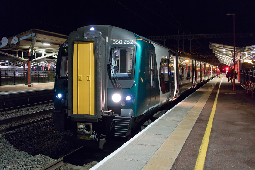 350252, LN 16.50 London Euston-Birmingham New Street (1Y61, 7L), Northampton station 
 After arrival at Rugby's relatively new platform one 350252 pauses with the 16.50 Euston to Birmingham New Street. My wife and I travelled up on this train from Northampton and found it very busy with the guard declassifying first class as is fairly common despite it being a twelve car working. That is fine if you are a standard class passenger standing nose to nose in a vestibule but if you were a first class season ticket holder I am pretty sure that you would be not quite so happy! 
 Keywords: 350252 16.50 London Euston-Birmingham New Street 1Y61 Northampton station