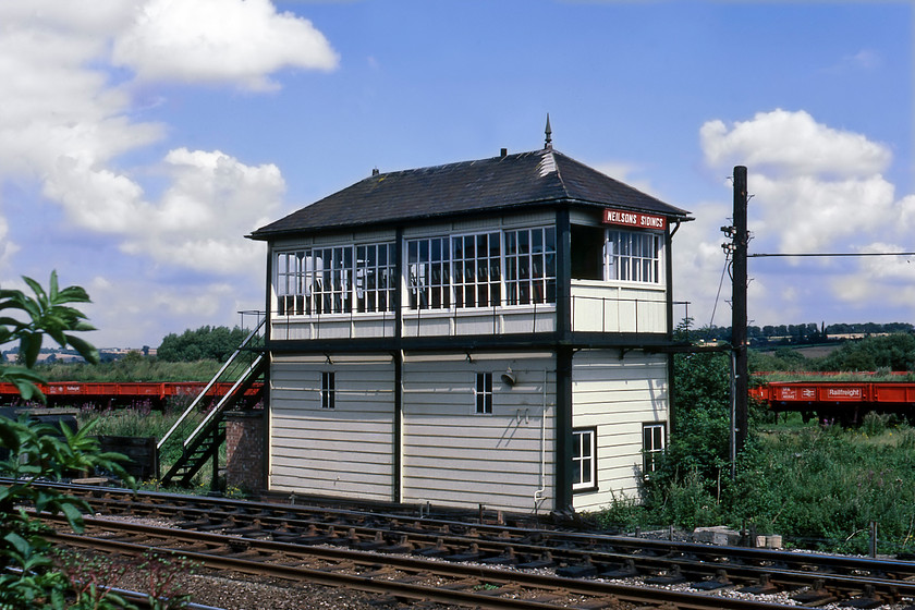 Neilson's Sidings signal box (Mid, 1893) 
 Neilson's Sidings signal box (as opposed to Neilson Sidings) is seen next to the Midland Mainline just north of Wellingborough's Finedon Raod sidings. The box is a superb and very well kept Midland 2B box that had just over another seven years in service until closure came as the so-called 'missing link' of mechanical signalling on the MML was replaced by MAS signalling. Notice that one of the finials is missing from the roof. Another published photograph shows the other had gone by the time closure came. 
 Keywords: Neilson's Sidings signal box