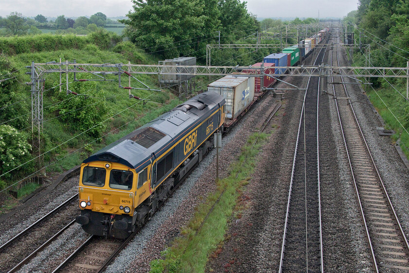 66715, 03.10 Felixstowe North-Trafford Park (4M18, 3E), Victoria bridge 
 After a bright start to the morning, it has clouded up and now is a very grey with typical flat lighting! 66715 'Valour' leads the daily 4M18 03.10 Felixstowe to Trafford Park GBRf service. The well-loaded train is seen passing Victoria bridge between Roade and Ashton. 
 Keywords: 66715 03.10 Felixstowe North-Trafford Park 4M18 Victoria bridge GBRf Valour