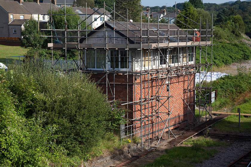 Tondu signal box (GWR, 1884) 
 Given that Tondu signal box has a extremely limited life remaining, it is quite surprising that Network Rail have cloaked it in scaffolding and appears top be giving it some maintenance. It looked as though there was work being done to the roof of the GWR Type 3 box dating from 1884. The work of the signalman will be a lot less that in past years when it was a busy junction handing a lot of coal trains with many of the 65 levers now being painted white as out of use. 
 Keywords: Tondu signal box