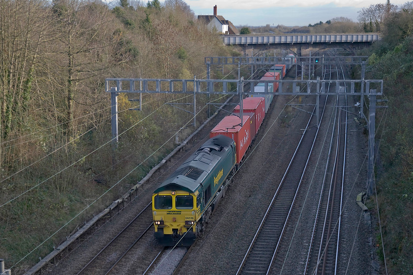 66615, 08.46 Felixstowe North-Crewe Basford Hall, Hyde Road bridge 
 66615 leading the 08.46 Felixstowe to Crewe Basford Hall Freightliner is about to enter Roade cutting passing under the village's Hyde Road bridge. It's early afternoon but already the sun has dropped away so as to leave the cutting in deep shadow as the shortest day is exactly a month away. 
 Keywords: 66615 08.46 Felixstowe North-Crewe Basford Hall Hyde Road bridge Freightliner