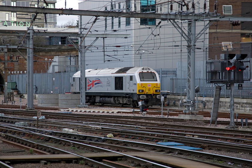 67026, stabled thunderbird, London KIng's Cross station 
 Against the gargantuan and somewhat austere backdrop of King's Cross' PSB 66026 'Diamond Jubilee' awaits its next call to action! It is stabled in a siding where the former King's Cross York Road station platforms used to be located the lines of which then passed into the disused Gasworks tunnel just seen to the extreme left. 
 Keywords: 67026 stabled thunderbird London KIng's Cross station Diamond Jubilee