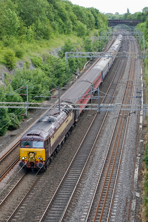 57305, 13.09 London Euston-Crewe down ecs (5Z58), Roade cutting 
 Having completed its Three Peak Challenge duties and dropped off the weary participants in London the stock is seen returning to Crewe. 57305 'Northern Princess' leads the 13.09 Euston to Crewe 5Z58 through Roade cutting. The very smart Northern Belle livery suits the class 57s very well. As 47164 in a previous life, this particular example was adorned with a huge union flag applied by Stratford depot to celebrate the Silver Jubilee in 1977. 
 Keywords: 57305 13.09 London Euston-Crewe down ecs 5Z58 Roade cutting Northern Princess Northern Belle