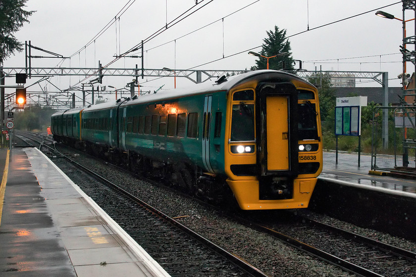 158838 & 150208, AW 07.34 Crewe & 07.50 Wrexham General-Birmingham International (1G93, 2L), Stechford station 
 In a picture that is more reminiscent of mid-January than August, the 07.34 Crewe and 07.50 Wrexham General to Birmingham International passes through Stechford station. I presume that the Wrexham train was formed by 158838 and the Crewe portion by 150208 with the two trains coming together at Shrewsbury. 
 Keywords: 158838 150208 07.34 Crewe 07.50 Wrexham General-Birmingham International 1G93 Stechford station