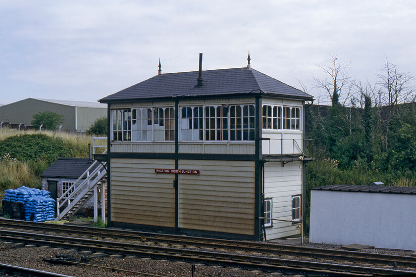 Syston South Junction signal Box (MR, 1890) 
 Syston South Junction signal box looks to be well stocked for the winter with a huge pile of coal bags conveniently placed at the bottom of the steps! The box was a Midland Railway Type 4c design which opened on 26.11.11 fitted with a fifty-seven-lever Midland Railway tappet frame. It was to close on 11.04.87 when signalling from Syston to Loughborough and Frisby passed to the Leicester PSB. Notice the London Midland & Scottish Railway Company post-1935 design nameboard unusually located on the front of the box rather than just below the gable ends as was the MR's usual practice; I hope that it was rescued when the box was unceremoniously demolished. 
 Keywords: Syston South Junction signal Box MR Midland Railway