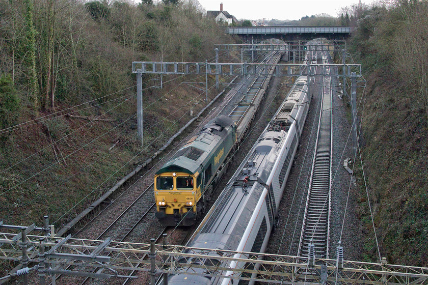 66511, 13.35 Drayton Road Junction-Bescot up engineers siding (6Y62, 93L) & 390123, VT 13.30 Birmingham New Street-London Euston (1B29, 1L), Hyde Road bridge 
 With the camera's ISO ramped up 66511 passes Roade with a train of used track panels as the 13.35 Drayton Road to Bescot 6Y62. The track panels have been recovered from what I believe to be the up fast line somewhere between Bletchley and Tring in the vicinity of Cheddington. As the train passes under the A508 road bridge 390123 heads south with the 13.30 Birmingham New Street to Euston Avanti service. 
 Keywords: 66511 13.35 Drayton Road Junction-Bescot up engineers siding 6Y62 390123 13.30 Birmingham New Street-London Euston 1B29 Hyde Road bridge Roade Freightliner Avanti West Coast Pendolino