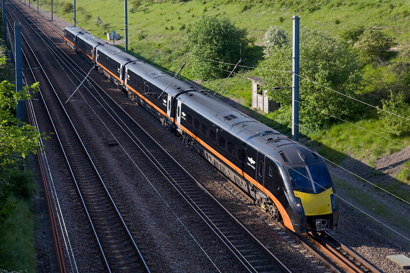 180101, GC 15.22 Bradford Interchange-London King's Cross (1A67), New England bridge TL219796 
 180101 takes the climb from Connington loop towards Huntingdon in its stride working the 15.22 Bradford Interchange to King's Cross service. Photographing trains in black livery (be they diesel or steam locomotives) is tricky at the best of times. With the large orange stripe along its flanks, the extreme contrast of the gloss black paint scheme is tempered slightly but some tinkering in Photoshop was still required. 
 Keywords: 180101 15.22 Bradford Interchange-London King's Cross 1A67 New England bridge TL219796 Grand Central