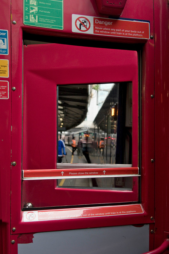 Looking through windows, 14.03 London Paddington-Penzance (1C84, 2E), London Paddington station 
 A scene soon to be banished from the network as the remaining slam-door trains are soon to be withdrawn from service. Here, the drop-lights of an HST are down and the doors open as the train is cleaned ready to depart soon as the 14.03 to Penzance. If ever there was a case for too many warning notices this has to be it. Psychologists have completed research finding that too many of these such notices cause 'unintentional blindness' towards them thus rendering them pointless. 
 Keywords: Looking through windows 14.03 London Paddington-Penzance 1C84 London Paddington station