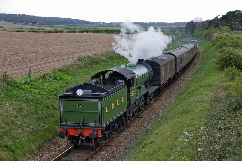 8572, 15.00 Holt-Sheringham, Dead Man's Hill 
 The second photograph of the day at Dead Man's Hill of LNER B12 8572. With the light having deteriorated now with very little blue sky it is seen passing tender first leading the 15.00 Holt to Sheringham service. In the middle distance, a trace of white smoke gives away 76084 leading the 15.00 Sheringham to Holt on the climb of Kelling bank. 
 Keywords: Poppy Line NNR North Norfolk Railway LNER B12 4-6-0 8572 15.00 Holt-Sheringham Dead Man's Hill