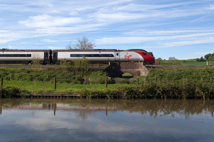 390148, VT 07.03 London Euston-Birmingham New Street (9G04, RT), Bugbrooke SP679564 
 With the Grand Union Canal in the foreground 390148 'Virgin Harrier' heads north near to Bugbrooke in Northamptonshire forming the 07.03 Euston to Birmingham New Street. To capture this image with no motion blur I used 1:2000/sec. From this distance it's sharp but close examination of the bodyside number revealed that 1:2500/sec would have been a better choice! 
 Keywords: 390148 9G04 Bugbrooke SP679564