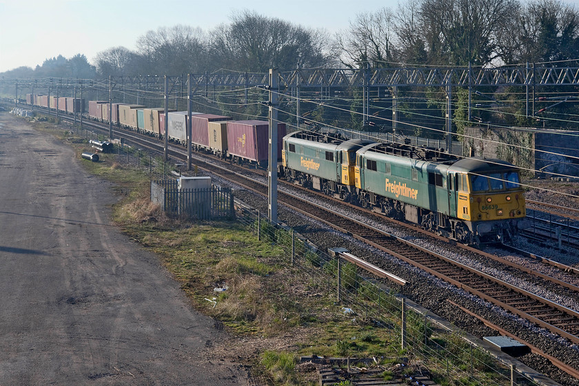 86639 & 86613, 02.50 Felixstowe North-Garston (4M45, 25E), site of Roade station 
 Veteran AC electric power still operates on the WCML, but for how much longer? With the reliability and scarcity of spares, the working lives of Freightliner's 86639 and 86613 must surely be coming to an end? They are seen leading the 02.50 Felixstowe North to Garston 4M45 service past the site of Roade station. 
 Keywords: 86639 86613 02.50 Felixstowe North-Garston 4M45 site of Roade station