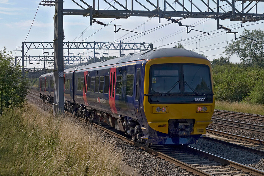 166221, 09.23 Wolverton Sidings-Reading Traincare Depot (5V65), Bradwell SP831391 
 Wreaking of fresh paint as it passes me at Bradwell in Milton Keynes is a First Great Western turbo unit 166221. It has just left Wolverton Works after a refurbishment and repaint and is heading back to its home base at Reading as 5V65. In order to take this photograph I was on the top of my step ladder leaning against the vicious palisade fencing but since the unfortunate event of a month ago, see..... https://www.ontheupfast.com/p/21936chg/C385151421/x32-three-peaks-challenge-19-06-14 I now protect myself from the spikes with my patented protection pad made up of an old car foot mat and insulation roll held on with bungee straps! 
 Keywords: 166221 09.23 Wolverton Sidings-Reading Traincare Depot 5V65 Bradwell SP831391 First Great Western Turbostar