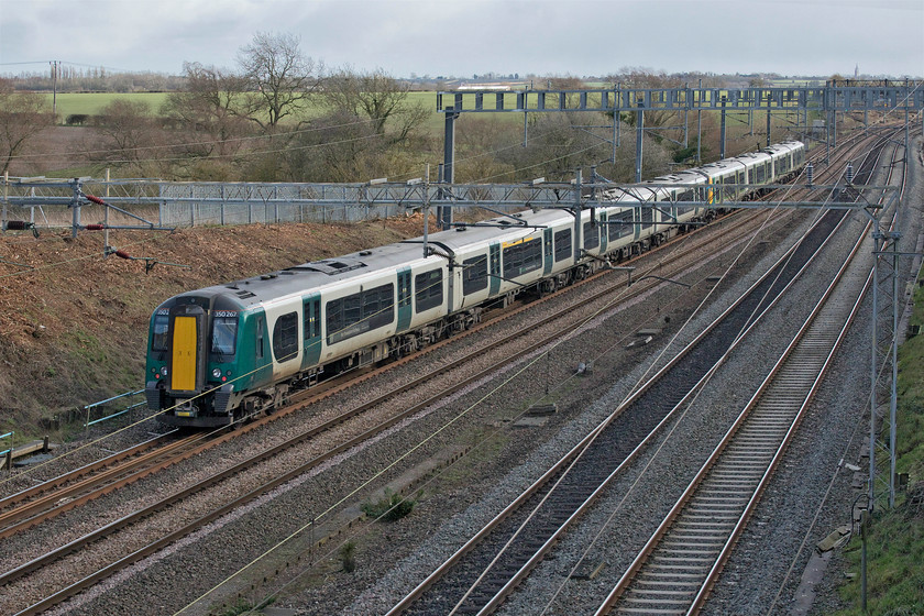 350267, LN 10.12 Liverpool Lime Street-London Euston (1Y58, 13L), Ashton Roade bridge 
 350267 brings up the rear of the 10.12 Liverpool to Euston service past Ashton Road bridge just south of the village of Roade. Notice the church spire of Hanslope's (as in the WCML junction) Grade 1 listed St. James the Great parish church on the skyline to the extreme right. This fine structure featured in an episode of 'Who Do You Think You Are?' with Patsy Kensit discovering that one of her ancestors was buried in the churchyard after becoming the curate of the church in 1841. 
 Keywords: 350267 10.12 Liverpool Lime Street-London Euston 1Y58 Ashton Roade bridge London Northwestern Desiro