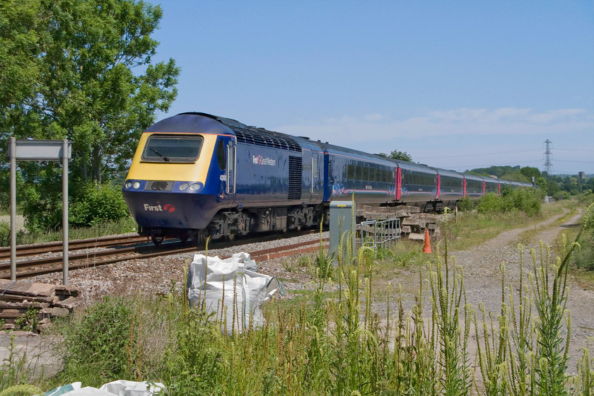 43160, GW 11.06 London Paddington-Plymouth (1C79), Victory level crossing, ST182249 
 Amongst the detritus left behind by Network Rail staff at Victory level crossing just west of Taunton 43160 gets up to speed for the accent of Whiteball bank. It really is criminal that the huge amount of waste seen laying around next to work sites is being paid for by you and I and not even as train travellers by as taxpayers. The HST is working the 11.06 Paddington to Plymouth 1C79 service on this glorious June day, one that got off to a very inauspicious start in Northampton! 
 Keywords: 43160 11.06 London Paddington-Plymouth 1C79 Victory level crossing ST182249 First Great Western HST