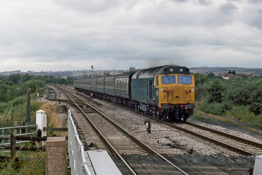 50029, 13.48 Plymouth-London Paddington (1A03), Athelney 
 With the tower of St. Bartholomews Church of East Lyng in the background, 50029 'Renown' is about to cross the River Tone and pass the level crossing at Athelney working the 1A03 13.48 Plymouth to London Paddington. 50029 is still operational having been withdrawn in early 1992. It is currently under a protracted restoration at Peak Rail being owned by the Renown Repulse Restoration Group. When I last saw it in 2016, it looked a bit sorry for itself..... https://www.ontheupfast.com/v/photos/21936chg/25743505804/x50029-rowsley-yard 
 Keywords: 50029 13.48 Plymouth-London Paddington 1A03 Athelney