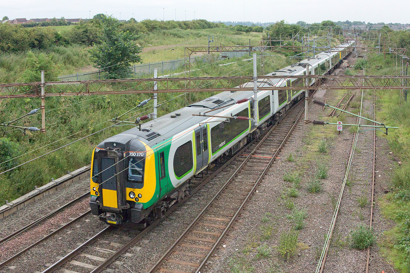 350370, LM 08.33 Birmingham New Street-London Euston (1W06), Mill Lane bridge, Northampton 
 The 1W06 08.33 Birmingham New Street to London Euston service approaches Northampton from the north formed of 350370 and a classmate. The train is about to go under Mill Lane bridge, a busy road and a bridge that requires some extra height to get a shot if you are vertically challenged like myself! 
 Keywords: 350370 08.33 Birmingham New Street-London Euston 1W06 Mill Lane bridge, Northampton