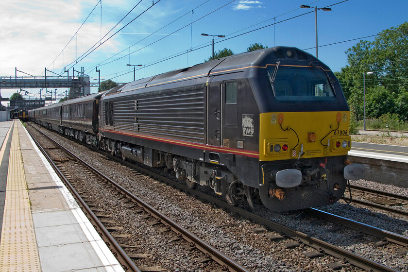 67006, Derby-Wolverton Centre Sidings Royal Train ECS, Northampton station 
 As a firm republican I am not a fan of the Royal Family by any stretch of the imagination! However, as a railway enthusiast, I am very keen on the continued existence of the Royal Train. I feel that it is vastly underused and it is regarded as a costly extravagance and as such, there is frequent talk of its scrapping. It is maintained at Wolverton Works and this is where it is seen returning to from Derby passing through Northampton station. 66005 'Queen's Messenger' is leading the formation of adapted Mk. III stock whist 67006 'Royal Sovereign' here brings up the rear. 
 Keywords: 67006 Derby-Wolverton Centre Sidings Royal Train ECS Northampton station Royal Sovereign