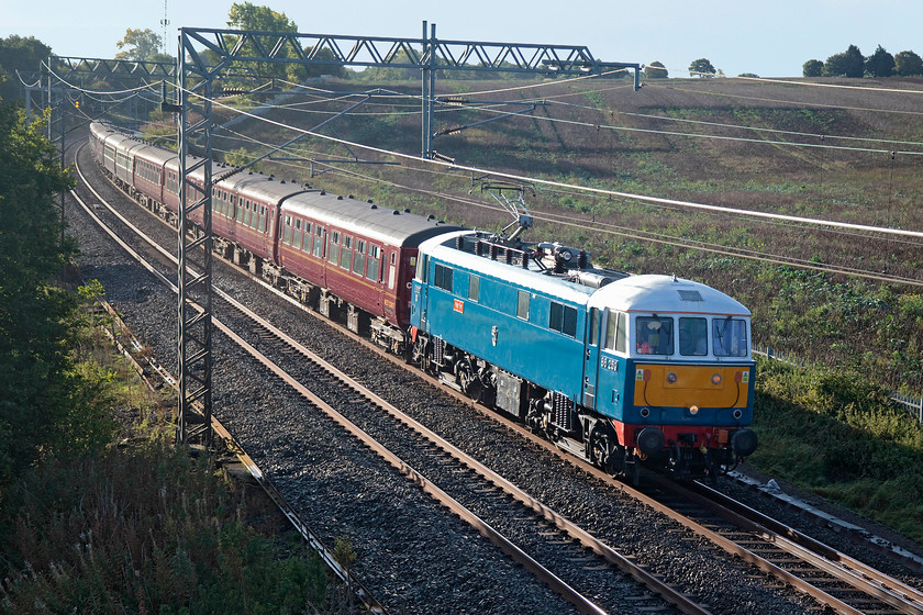 86259, outward leg of The Cathedrals Express, 07.10 London Euston-Carlisle (1Z86), Milton Crossing 
 86259 'Les Ross/Peter Pan' leads the 1Z86 07.10 Euston to Carlisle running as The Cathedrals Express. The veteran electric hauled the train to Carnforth where 45690 'Leander' hauled the train over Shap to Carlisle and then back south over the Settle and Carlisle to Farrington Junction. The train is seen passing Milton Crossing between Roade and Blisworth on the Weedon Loop. 
 Keywords: 86259 The Cathedrals Express 07.10 London Euston-Carlisle 1Z86 Milton Crossing