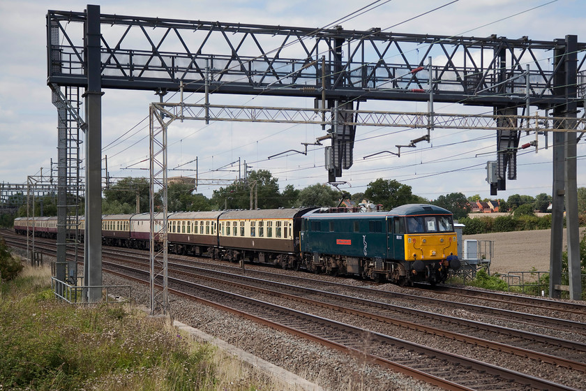 86101, The Absent Shunter, 08.33 Newcastle-Basingstoke (1Z07), Ashton Hill 
 The 1Z07 Absent Shunter railtour started out at Newcastle earlier this morning. It was supposed to have had 47749 hauling the first leg to Crewe but 66762 had to be substituted due to failure of the 47. Here, 86101 'Sir William A Stanier' brings the second leg past Ashton Hill south of Roade on the WCML. The 86 took the train to Euston where 66723 'Chinook' took the final leg to Basingstoke. 
 Keywords: 86101 The Absent Shunter 08.33 Newcastle-Basingstoke 1Z07 Ashton Hill