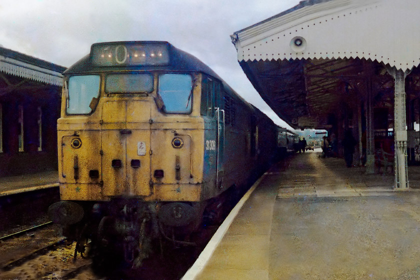 31309, 1158 Weymouth-BTM, Westbury station 
 31309 stands at Westbury station leading the 11.58 Weymouth to Bristol Temple Meads working. In this picture, the Bescot based 31 is looking a bit tatty. In later years it moved east, regained its trademark white stripe and was renamed Cricklewood. Notice that three of the headcode display blinds have been removed leaving the bulbs that illuminate them from the rear exposed through the glass. 
 Keywords: 31309 Westbury station Weymouth to Bristol Temple Meads