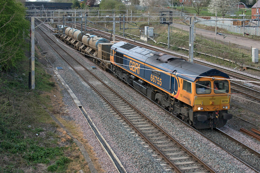 66755, 14.58 King`s Norton OT-Horsham, terminated at Redhill (6Z66, 9E), site of Roade station 
 With their use over until the autumn, the RHT tanks and pumps are taken from their base at Kings Norton just south of Birmingham. Originally, the 14.58 Kings Norton to Horsham 6Z66 had a Class 66 at both ends, but 66759 was removed at Landore Street leaving 66755 'Tony Berkeley OBE RFG Chairman 1997-2018' to lead the train south. Plans changed again later as the train was terminated on arrival at Redhill. The unusual working is seen passing the site of Roade's former station on the up fast line. 
 Keywords: 66755 14.58 Kings Norton OT-Horsham Redhill 6Z66 site of Roade station Tony Berkeley OBE RFG Chairman 1997-2018 RHT