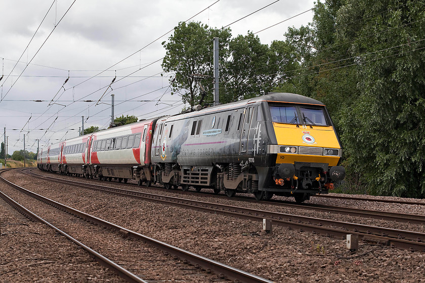 91110, GR 10.03 London Kings Cross-Leeds (1D09, 2L), Offord DArcy TL213655 
 91110 in its celebrity 'Battle of Britain Memorial Flight' livery leads the 10.03 London King's Cross to Leeds. The train is seen passing a remote and little used foot crossing just south of Offord DArcy between St. Neots and Huntingdon. I have often though how good it would have looked if there had been a dedicated set of Mk.IV stock matching the livery of 91110 and its cousin 91111 'For the Fallen'. 
 Keywords: 91110 1D09 Offord DArcy TL213655