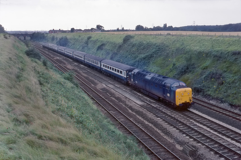 55011, 08.05 London King's Cross-Hull (1D00), Essendine TF043129 
 55001 'The Royal Northumberland Fusiliers' leads the 08.05 King's Cross to Hull express past Essendine on the southern flank of Stoke bank. The Deeltics were as well suited to these shorter diagrams with plenty of stops and starts as they were to to the longer distance workings with more sustained periods of high speed running. As with the last photograph, the scene is very different now, see..... https://www.ontheupfast.com/p/21936chg/26500882204/x801201-09-41-peterborough-doncaster 
 Keywords: 55011 08.05 London King's Cross-Hull 1D00 Essendine TF043129 Deltic The Royal Northumberland Fusiliers