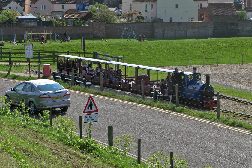 Howard, 15.10 Wells-next-the Sea-Pinewoods, Wells-next-the-Sea station 
 Taken from the top of the bunding with the road below the 15.10 Wells Harbour to Pinewoods Hills is preparing to leave with 'Howard' leading the train. During the high season, the trains are usually packed to the gunwales with many seeking to avoid the long walk with all the paraphilia to the beach at Holkham Bay. 
 Keywords: Howard 15.10 Wells-next-the Sea-Pinewoods Wells-next-the-Sea station