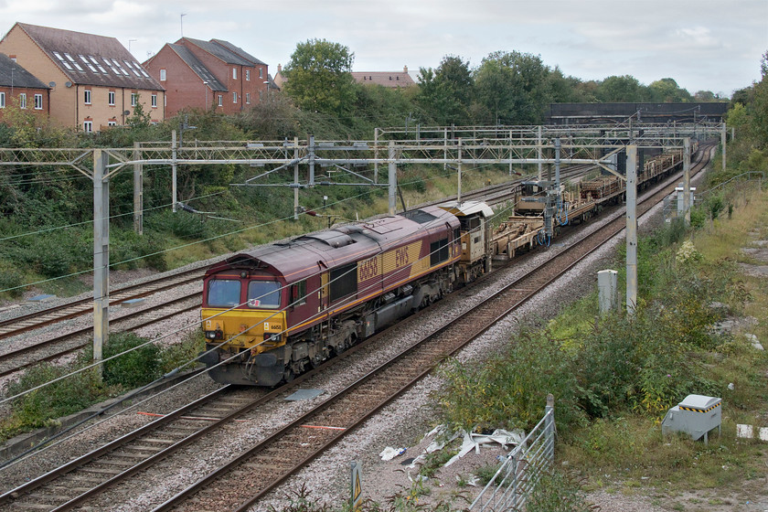 66158, 12.00 Euston-Bescot (6R05, 28L), site of Roade station 
 66158 brings up the rear of the 12.00 Euston to Bescot engineering train. The flatbed wagons are seen loaded with track panels removed from overnight engineering works in the throat of Euston station that, on this occasion, over ran causing huge delays including this actual train that was over an hour adrift here passing Roade. 
 Keywords: 66158 12.00 Euston-Bescot 6R05 site of Roade station EWS