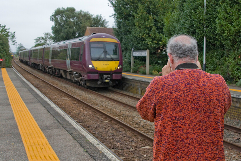 Andy & 170504 & 170204, EM 15.12 Skegness-Nottingham (2O20, 15L), Heckington station 
 A study of the railway photographer at work! Andy is probably struggling to capture 170504 and 170204 as it arrives at Heckington with the 2O20 15.12 Skegness to Nottingham service. I say struggle as he was having 'technical issues' with the camera sporadically failing to fire caused, I believed, by a stuck lens iris. His camera and lens date from the early noughties so I am trying to persuade him to spend a little of his hard-earned pension! 
 Keywords: Andy 170504 170204 15.12 Skegness-Nottingham 2O20 Heckington station EMR East Midlands Railway