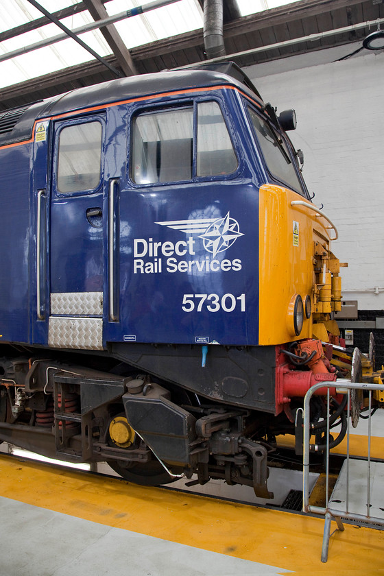 57301, on-display, DRS Open Day, Gresty Bridge 
 Built at Crewe during 1964 D1653 operated around the Western Region being allocated to all their depots at various times from Laira to Old Oak Common. In January 1974 it became 47069 moving away from the west to Bescot and Crewe where it became 47638 and was named 'County of Kent'. It was a Porterbrook and Great Western Trains locomotive during early privatisation as 47845. Finally, in 2002 it was rebuilt and became 57301 named 'Scott Tracy' becoming one of Virgin's infamous red Thunderbirds for rescuing failed Pendolinos and Voyagers. Now in DRS Compass livery, it is still in use on various duties all over the network. One wonders if this is the last number it will carry and what the next fifty five years hold for this evergreen veteran? 
 Keywords: 57301 DRS Open Day Gresty Bridge