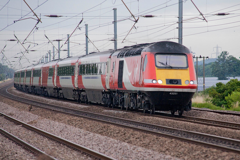 43241, GR 07.15 Leeds-London Kings Cross (1A09, 3L), Sandy TL176510 
 Of all the liveries that east coast train sets have carried, I think that the VTEC red and white is one of the best. Many people rated the GNER blue but as a photographer, it was often difficult to photograph rather like the GWR new green livery. Here, 43241 (ex. 43041, ex. 253020) leads the 07.15 1A09 Leeds to King's Cross past New Zealand bridge just north of Sandy. 
 Keywords: 43241 1A09 Sandy TL176510