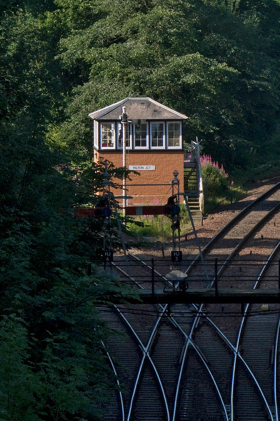 Hilton Junction signal box (Caledonian, 1873) 
 This signal box proved to be very awkward to get to and even then I only managed this rather distant photograph. Hilton Junction signal box is reputedly Scotland's oldest box still in use dating from 1873 and is of a classic Caledonian Railway design. Unfortunately, the rare gantry supported on the retaining walls of the cutting that supports junction signals HJ6 and HJ3 is in total shade. The former signal routes trains towards Ladybank and the latter towards Dunblane and Stirling. 
 Keywords: Hilton Junction signal box Caledonian Railway