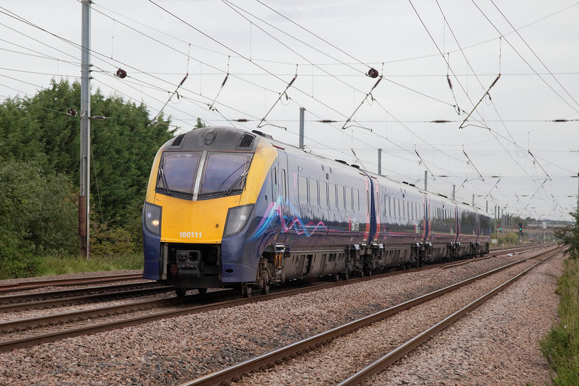 180111, HT 08.23 Hull-London Kings Cross (1A92, RT), Holme Green Crossing TL192426 
 Hull Trains is an open access operator that is owned by First Group, who themselves have their fingers in many TOC pies! Hull Trains has an access agreement for another eleven years until 2029 so it will be interesting to see how heir operations progress. For the moment, they use these Coradia family class 180s that utilise hydraulic transmission. 180111 passes Holme Green farm crossing with the 08.23 Hull to King's Cross. 
 Keywords: 180111 1A92 Holme Green Crossing TL192426