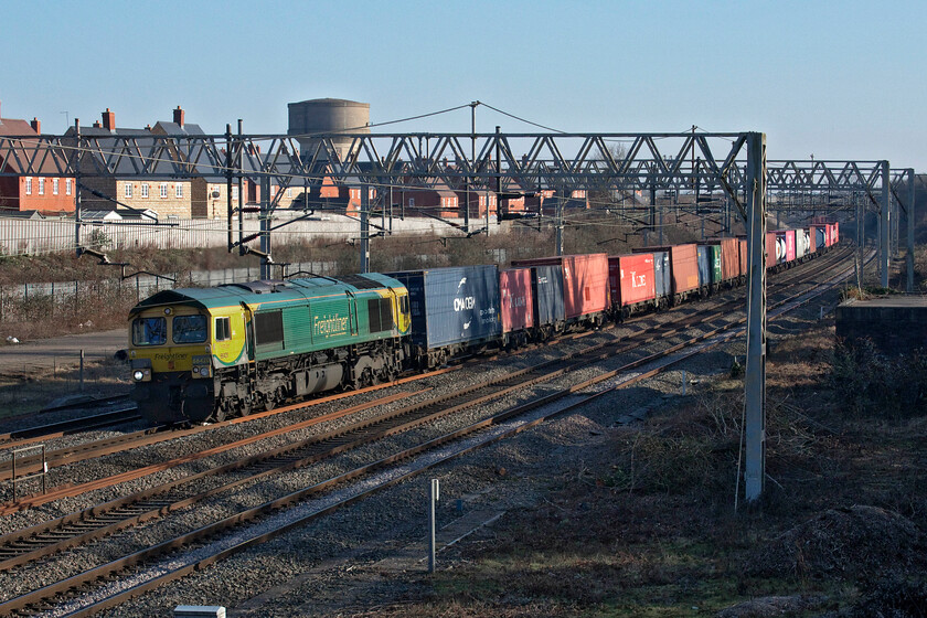 66420, 09.27 Southampton MCT-Garston (4M58, 29E), site of Roade station 
 In glorious afternoon sunshine 66420 passes the site of Roade station leading the daily 4N58 Southampton to Gaston Freightliner service. I have never quite understood why this particular freight service takes the WCML route whilst all of the others to and from Southampton take the GWR route via Banbury, Oxford and Reading; advice please? 
 Keywords: 66420 09.27 Southampton MCT-Garston 4M58 site of Roade station