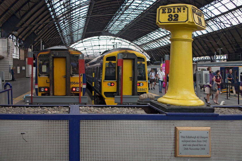 156447, SR 12.18 Glasgow Queen Street-Alloa (2N69, 1E) & 158867, SR 11.21 Anniesland-Glasgow Queen Street (2W70, RT), Glasgow Queen Street station 
 The stops at Glasgow Queen Street proudly display an 1842 milepost. Behind it to the left is 156447 that will work the 12.18 to Alloa. To the right, 158867 has just arrived with the 11.21 from Anniesland with its passengers making their way along the platform. 
 Keywords: 156447 2N69 158867 2W70 Glasgow Queen Street station