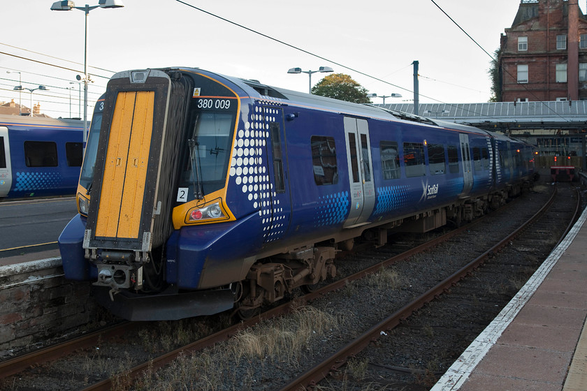 380009, stabled, Ayr station 
 On arrival at Ayr, 380009 is pictures sitting in one of the bay platforms ready for its next turn of duty, probably a morning commuter working. During our visit, the main station building was cordoned off due to masonry recently falling on to the platforms. Extensive emergency work was being undertaken to repair the building that meant complete closure. Just to my right in this image, ScotRail had set up a temporary ticket gate line. 
 Keywords: 380009 Ayr station