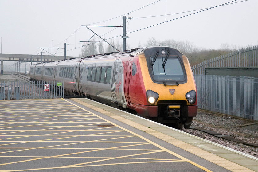 Class 221, VT 10.10 London Euston-Chester (1D84), Milton Keynes Central station 
 A class 221 slows for its Milton Keynes stop with the 1D84 10.10 Euston to Chester. With their numbers so low down on a cowling it is very difficult to identify the set numbers of these Voyagers. This is unlike their class 222 Meridian cousins that have their numbers emblazoned across the nose right where the Virgin badge is affixed on these Voyagers. 
 Keywords: Class 221 VT 10.10 London Euston-Chester 1D84 Milton Keynes Central station