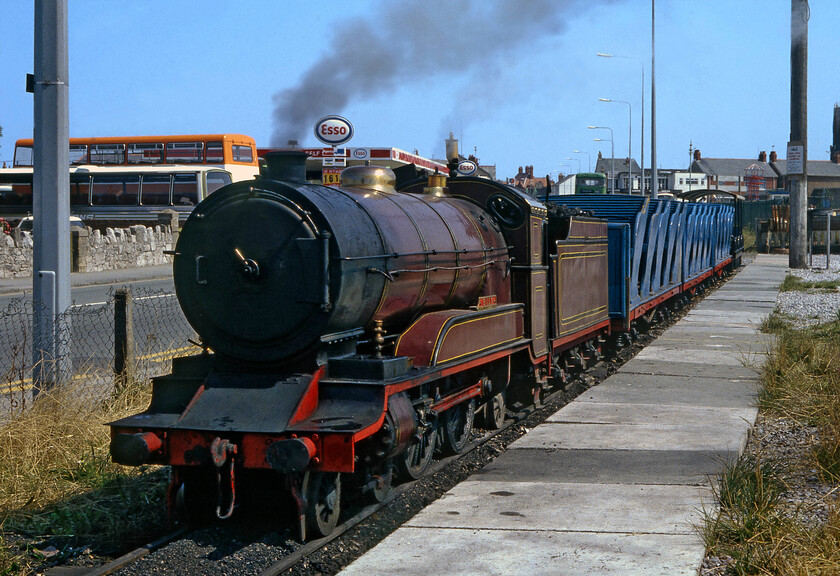 106, Rhyl Marine Lake 
 The fifteen-inch narrow gauge Rhyl Marine Lake railway has been a popular holiday attraction in the North Wales resort for over one hundred years (apart from a short break between 1970 and 1978) and is still in operation to this day. On the day that Graham and I visited the town 1930 built 106 'Billy' was in steam and is seen waiting at Central station on Wellington Road. This locomotive is now stored and on public display in the railway's museum waiting for a full restoration and a possible return to service. Notice the Esso fuel station in the background advertising two-star petrol at 1.61 per gallon this land is now covered by a large retail park with the beach beyond. 
 Keywords: 106 Rhyl Marine Lake