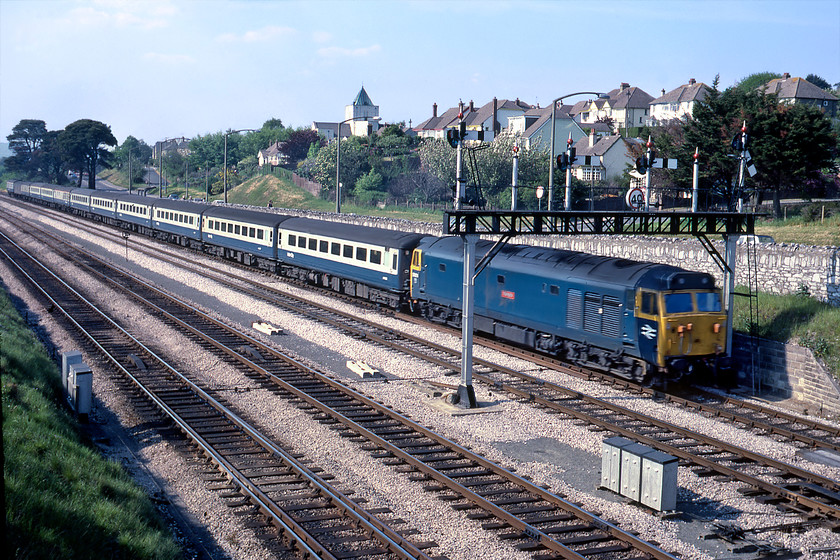 50014, 13.30 London Paddington-Paignton (1B84), Aller Junction 
 The 13.30 Paddington to Penzance 1B84 rushes past Aller Junction led by 50014 'Warspite'. Unfortunately, the limited shutter speed of the Rollie B35 camera has meant some motion blur has marred the image. 50014 soldiered on in this livery in an un-refurbished condition for nearly another four years, being the last member of the class to leave Doncaster works in December 1983.

There is an audio recording of this event on my youtube channel, see....https://youtu.be/JOv2duTje6I 
 Keywords: 50014 13.30 London Paddington-Paignton Aller Junction Warspite