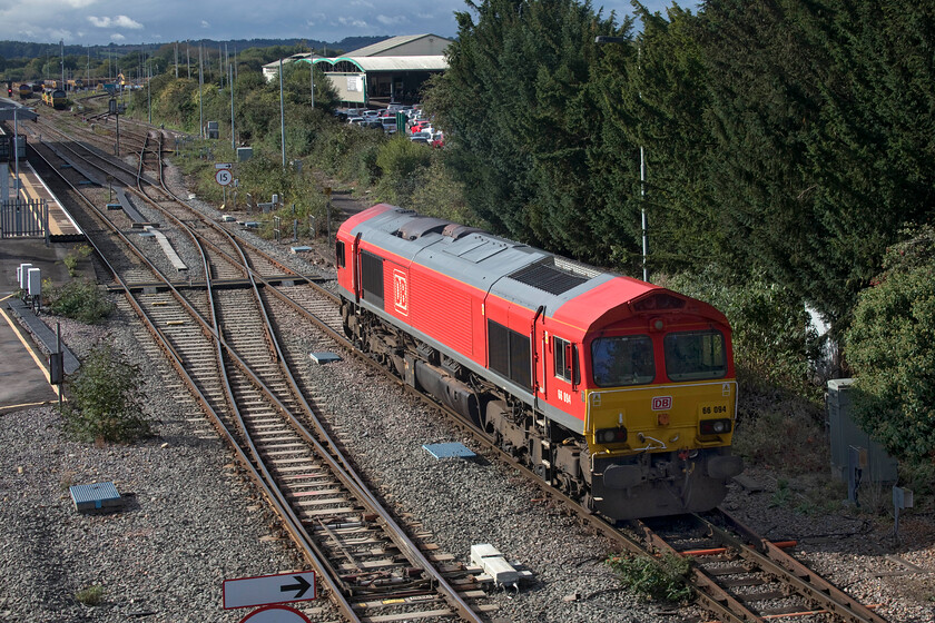 66094, running round, Westbury station 
 I am not sure where 66094 had appeared from but it had come in from the Trowbridge direction. It was signalled to enter the yard and then disappeared out of sight. This is my first photograph of this locomotive in its DB livery, just over a year ago it was still in its as-built EWS paint scheme, see.... https://www.ontheupfast.com/p/21936chg/29019904204/x66094-14-47-dirft-dollands-moor 
 Keywords: 66094 Westbury station DB