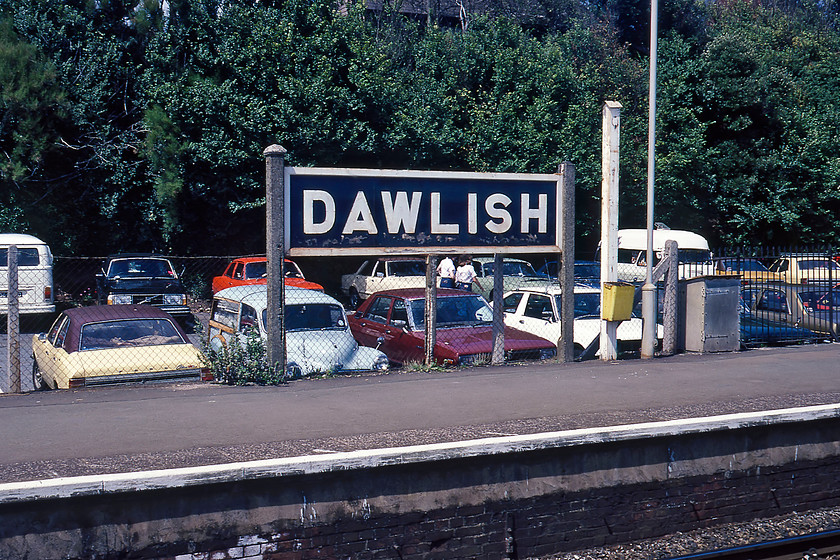 Ex GWR sign, Dawlish station 
 A second GWR running-in board at Dawlish station on the up platform. The car park in the background was once the goods sidings where a small shed once also existed. Of particular interest is the collection of 1970s cars. With a number of Ford Cortinas, there are at least two Japanese interlopers in the form of Datsun, a Morris Minor Traveller, a smart looking Vovo 240 and a VW Camper. 
 Keywords: Ex GWR sign Dawlish station