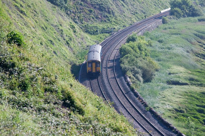 150213, AW 07.07 Cardiff Central-Cheltenham Spa (2G52, RT), Purton SO672049 
 Recent clearance, by a specialist Network Rail team, of the precipitous face seen on the left in this image has opened up this view and many more in the vicinity. Looking a little into the early morning sun, 150213 heads away working the 07.07 Cardiff Central to Cheltenham Spa. The area to the right is the bank of the River Severn between the tiny villages of Purton and Gatcombe in Gloucestershire. 
 Keywords: 150213 2G52 Purton SO672049