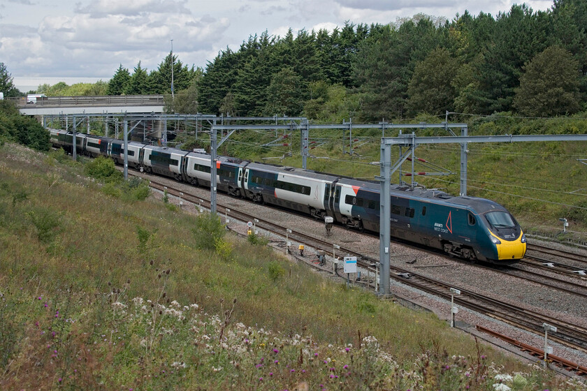 390020, VT 10.55 Manchester Piccadilly-London Euston (1A29, 6L), Loughton Redway bridge, Milton Keynes 
 The railway through Milton Keynes is not renowned for its photographic opportunities with few spots available with most requiring the use of a step ladder. As I was working very close to this location, the Redway bridge that spans both the railway and the parallel running A5 in the Loughton area of the city, I thought I'd try my luck. Whilst the foreground is relatively open a full train's length does not quite fit in the gap up to the A509 overbridge. 390020 heads south working Avanti's 10.55 Manchester to Euston service. 
 Keywords: 390020 10.55 Manchester Piccadilly-London Euston 1A29 Loughton Redway bridge Milton Keynes AWC Avanti West Coast Pendolino