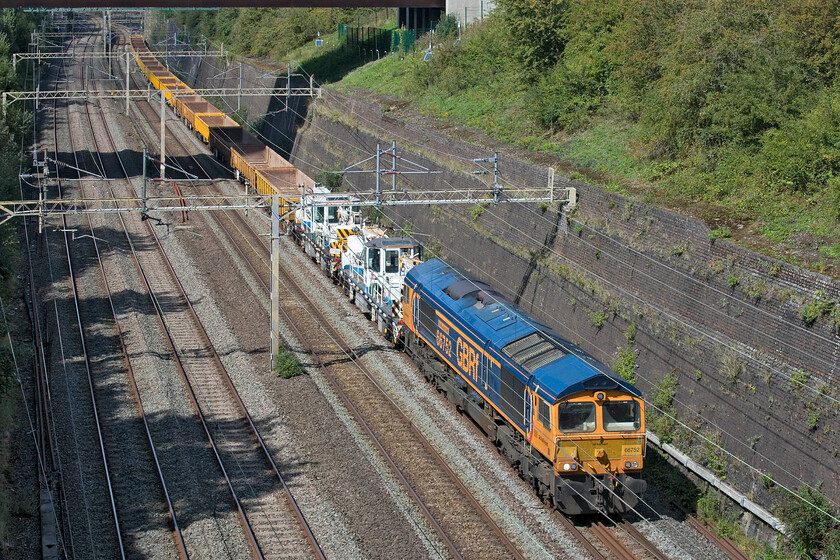 66752 & 66762, 11.42 Bescot Yard-Wolverton (via Wembley) (7G52, 15E), Roade cutting 
 66752 'The Hoosier State' gets no assistance from 66762 (at the rear) as it lifts the 11.42 Bescot Yard to Wolverton (via a Wembley reversal) engineering train through Roade cutting after the steady climb from Northampton. Another example clear to see here of a smartly turned-out GBRf locomotive, something that the freight operator is noted for. 
 Keywords: 66752 66762 11.42 Bescot Yard-Wolverton via Wembley7G52 Roade cutting GBRF infrastructure engineering