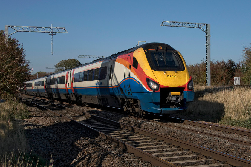 222010, EM 14.41 Corby-London St. Pancras (1P50, 5L), Irchester SP927667 
 In stunning autumn light, 222010 races past Irchester just south of Wellingborough working the 14.41 Corby to St. Pancras 1P50 service under the newly installed electrification masts. The weather on this particular day was unseasonally balmy, making it the warmest October day for seven years. 
 Keywords: 222010 14.41 Corby-London St. Pancras 1P50 Irchester SP927667