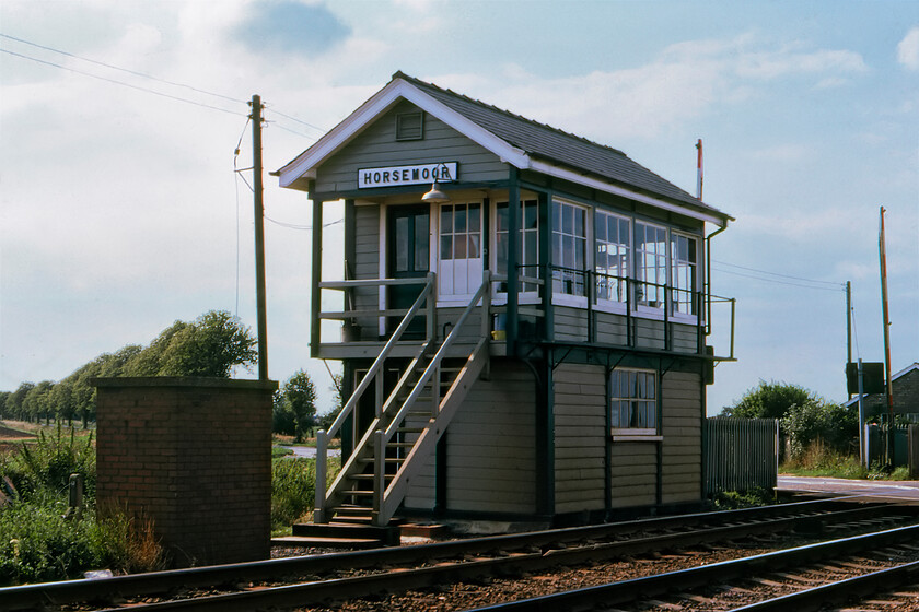 Horsemoor signal box (GE, 1889) 
 This was as far east as Graham and I would venture today with the focus of our activity to document the doomed GNR/GER Joint line that ran between Spalding and March. Horsemmor signal box was located to the east of March on the Ely line where it crossed the B1099 Upwell Road. This was only a short distance from March South signal box with the next one in the other direction being Stonea. Opened in 1899 by the Great Eastern it was unusual in having a covered landing and a window arrangement of small panes above tall that appeared to be unique for this particular design of box. The box shut on 13.11.88 with an anonymous grey relay room and full barriers replacing it, however, the structure was carefully dismantled and is now located in a reclamation yard at nearby Murrow, see.https://www.ontheupfast.com/p/21936chg/30044473940/former-horsemoor-signal-box-murrow 
 Keywords: Horsemoor signal box Great Eastern Railway