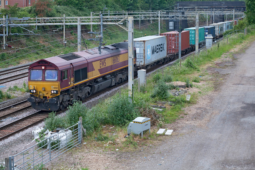 66063, 13.15 Trafford Park-London Gateway (4L56, 10E), site of Roade station 
 It is quite staggering that eleven years after the rebranding of EWS commenced following its take over by DB two years earlier in 2009 that there are still a fair number of Class 66s that are not only in the original livery but still wearing full EWS branding. 66063 is one of these locomotives seen passing Roade leading the 4L56 13.15 Trafford Park to London Gateway Freightliner train. I have said this a number of times but I wonder when the last three beasts and EWS lettering will be removed from the flanks of a Class 66? 
 Keywords: 66063 13.15 Trafford Park-London Gateway 4L56 site of Roade station EWS Freightliner