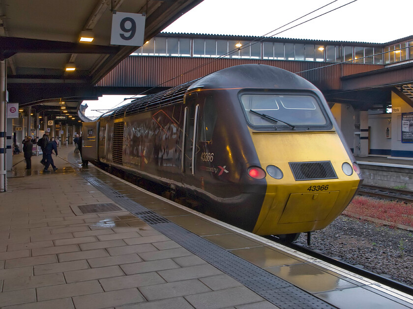 43366, XC 06.06 Edinburgh Waverley-Plymouth (1V50), York station 
 In torrential rain that was, as can be seen here, causing platform staff some issues 43366 stands at the rear of the 06.06 Edinburgh to Plymouth HST service. This CrossCountry power car was introduced from the summer of 1982 when BR introduced HSTs on this route replacing locomotive-hauled services. In this case, 43166 was part of set 253042 that was nominally paired with 43165 which spent their working lives on this route serving passengers ever since. 
 Keywords: 43366 06.06 Edinburgh Waverley-Plymouth 1V50 York station CrossCountry HST